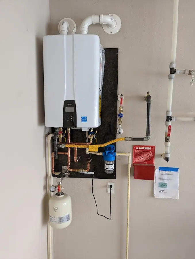 Professional plumber installing copper piping in a Longwood home